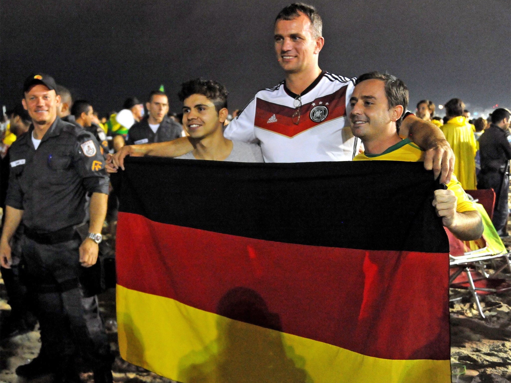 A German fan with Brazilian supporters at the Fan Fest in Rio de Janeiro that followed Tuesday’s World Cup semi-final